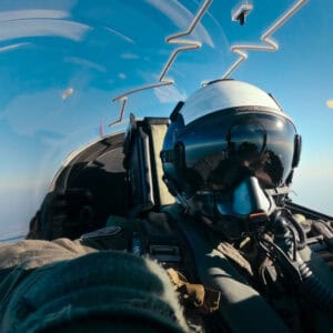 Fighter pilot in cockpit flying
